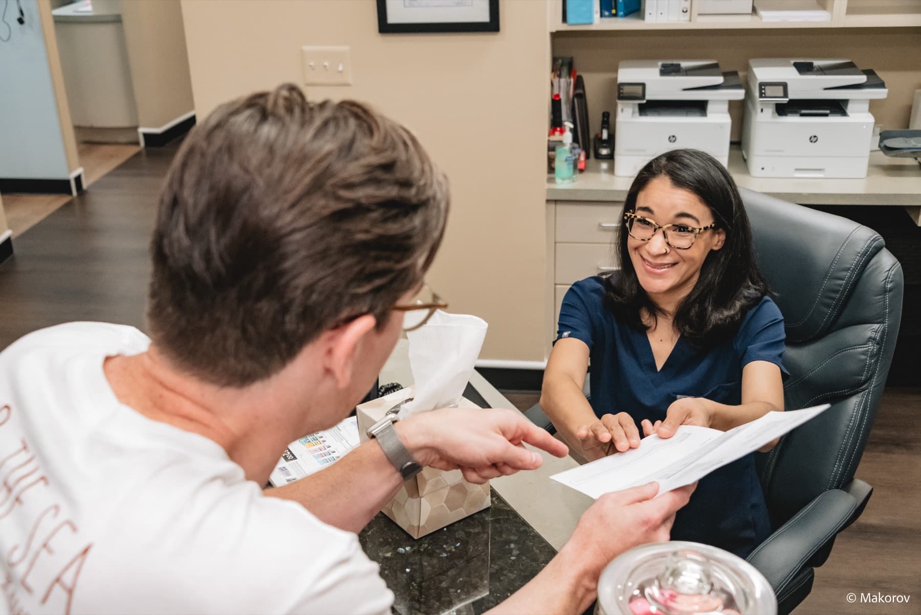 Team member reviewing paperwork with a patient