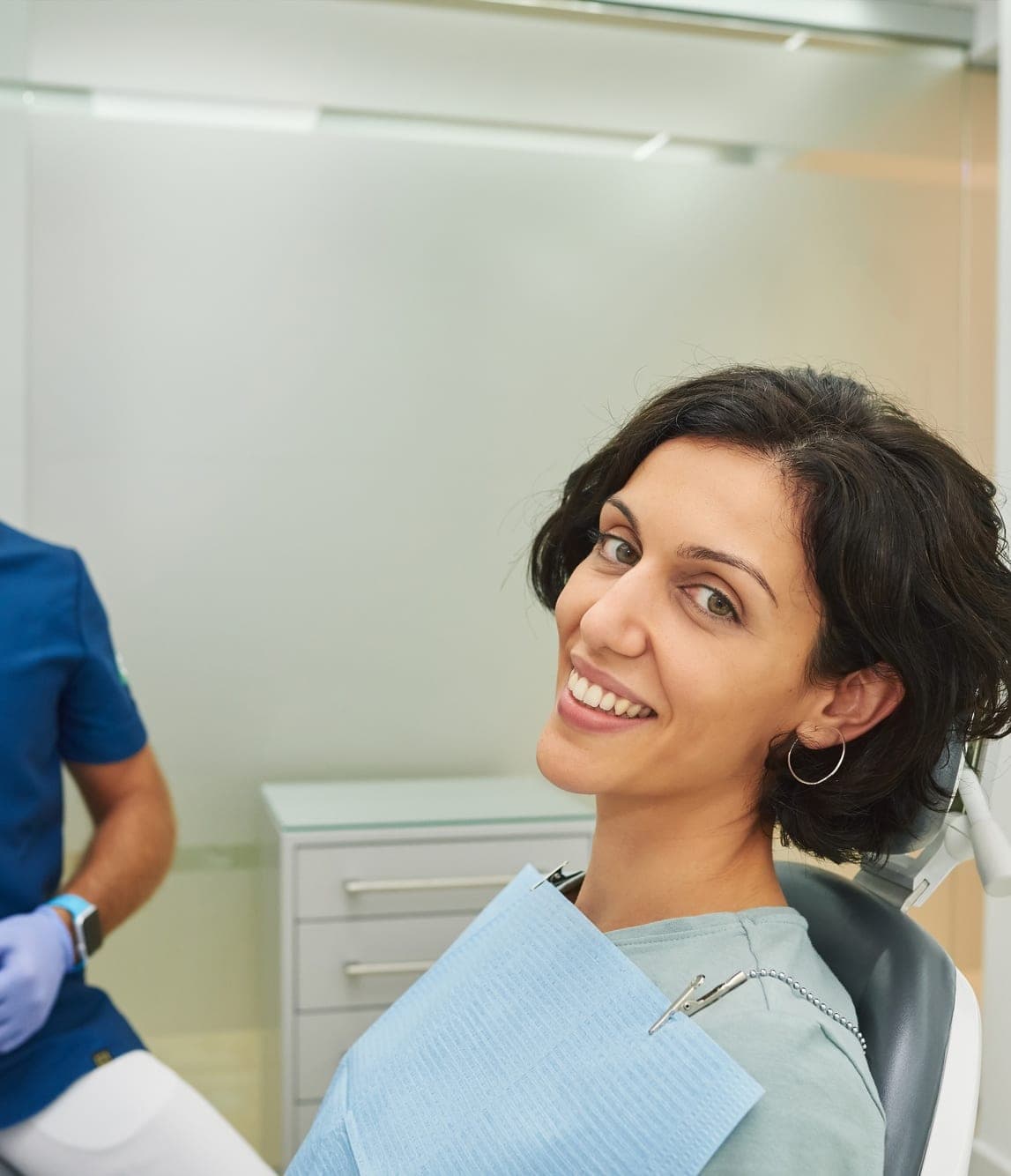 Smiling patient in the dental chair with her dentist