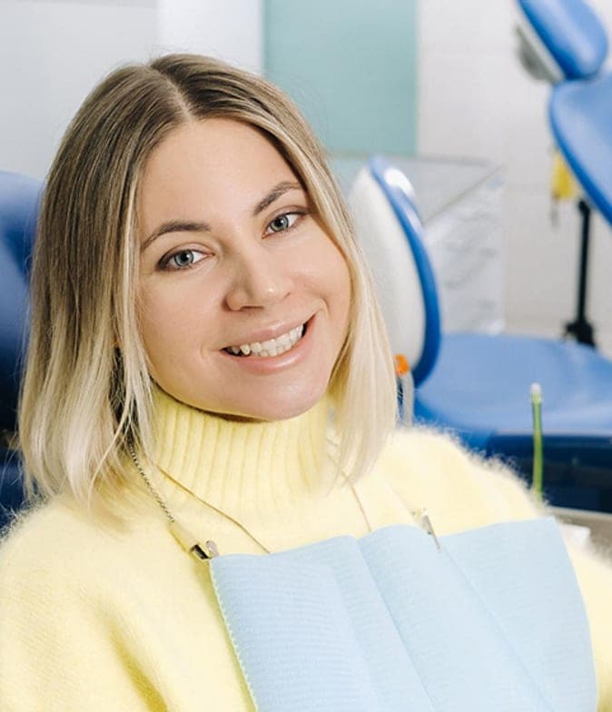 Smiling woman relaxing in the dental chair